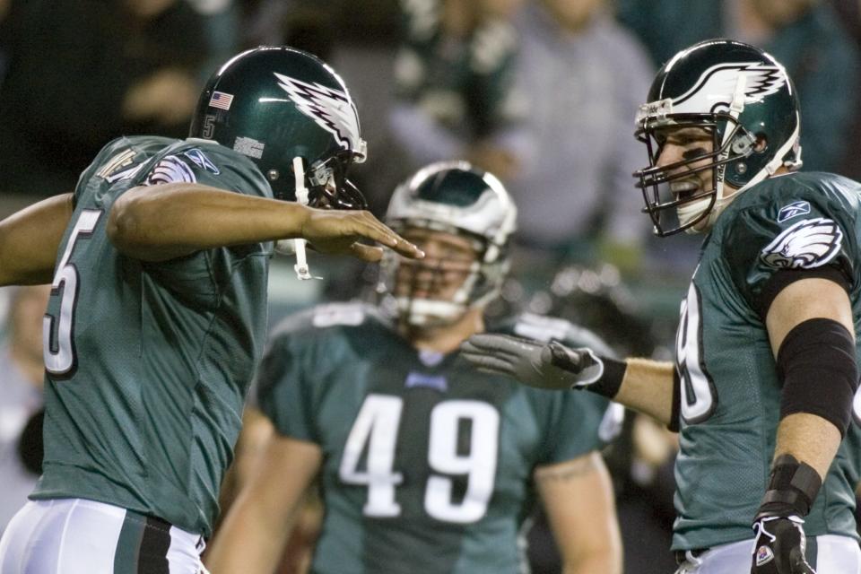 Philadelphia Eagles quarterback Donovan McNabb celebrates a touchdown with tight end Chad Lewis, right, during a 2005 game against the Dallas Cowboys. Lewis was a college teammate of quarterback Steve Sarkisian's at BYU, and caught seven touchdown passes from the future Texas head coach.