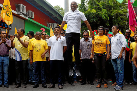 Ibrahim Mohamed Solih, Maldivian presidential candidate backed by the opposition coalition, jumps next to his supporters during the final campaign rally ahead of the presidential election in Male, Maldives September 22, 2018. REUTERS/Ashwa Faheem