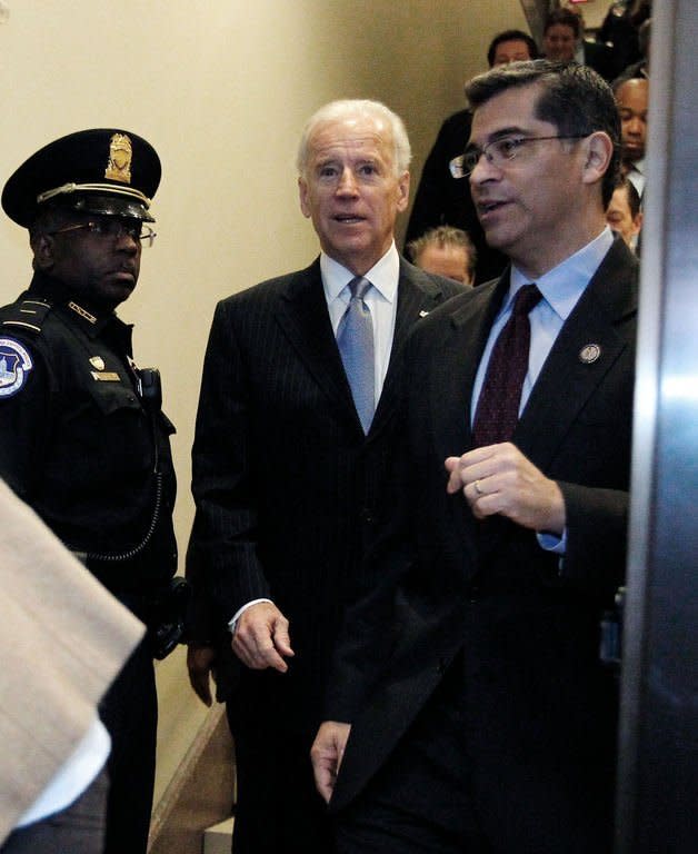 US Vice President Joe Biden arrives with Representative Xavier Becerra (R) to the US Capitol to meet with reluctant House Democrats on January 1, 2013 in Washington, DC. After a day of twisting political drama, the US Congress was expected to finally endorse a deal to avert the "fiscal cliff" budget crisis that had threatened to unleash a new recession