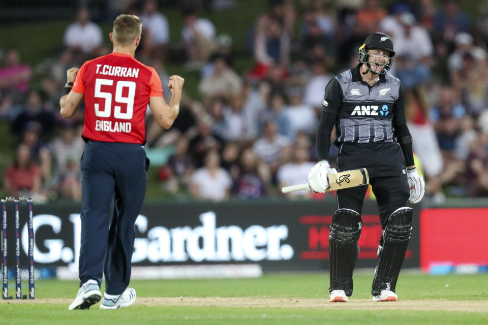 New Zealand batsman Martin Guptill, right, reacts as England bowler Tom Curren celebrates his wicket during the T20 cricket match between England and New Zealand in Napier, New Zealand, Friday, Nov. 8, 2019. (John Cowpland/Photosport via AP)