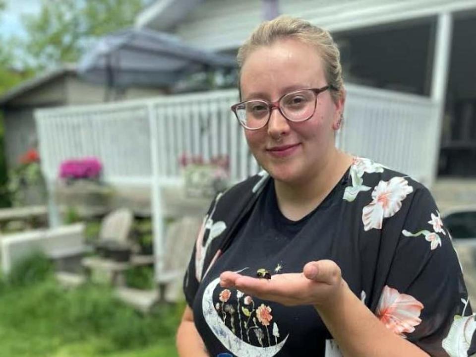 Megan Day, who lives in the Mohawk community of Kahnawake southwest of Montreal, says she has been impressed by the amount of life her uncut grass attracts.  (John Ngala/CBC - image credit)