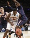 Iowa State's Daniel Edozie, center, loses the ball while covered by Connecticut's Niels Giffey, left, and Amida Brimah during the first half in a regional semifinal at the NCAA college basketball tournament Friday, March 28, 2014, in New York. (AP Photo/Frank Franklin II)