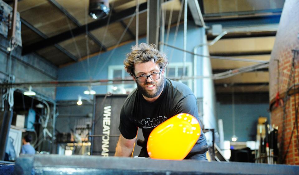 Staff at the Wheaton Arts glass blowing demonstration create ornamental pumpkins before the Festival of Fine Craft in Millville in this Daily Journal file photo.