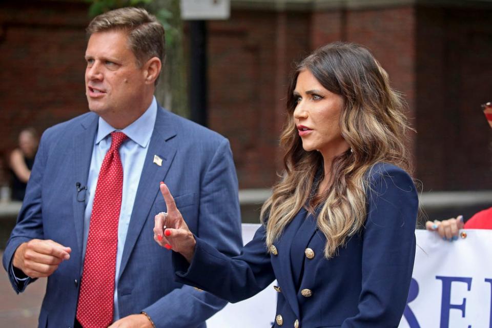 Massachusetts Republican gubernatorial candidate Geoff Diehl, left, campaigns with Republican South Dakota Gov. Kristi Noem, right, in the North End neighborhood of Boston, Thursday, Aug. 11, 2022.