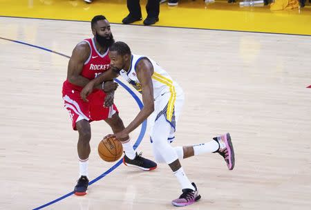 May 20, 2018; Oakland, CA, USA; Golden State Warriors forward Kevin Durant (35) drives in against Houston Rockets guard James Harden (13) during the third quarter of game three of the Western conference finals of the 2018 NBA Playoffs at Oracle Arena. Mandatory Credit: Kelley L Cox-USA TODAY Sports