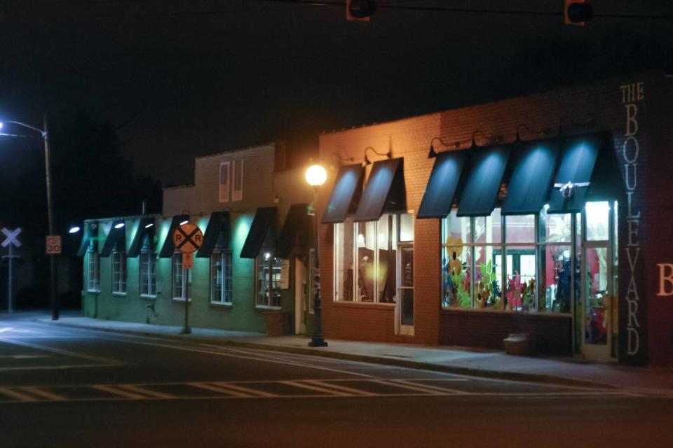 The Boulevard at NoDa, Lark & Key Gallery and Boutique and Green Rice Designs are shown at the corner of North Davidson and 36th Streets in the early 2000s. The buildings are now home to The Blind Pig and The Exchange at 36th.