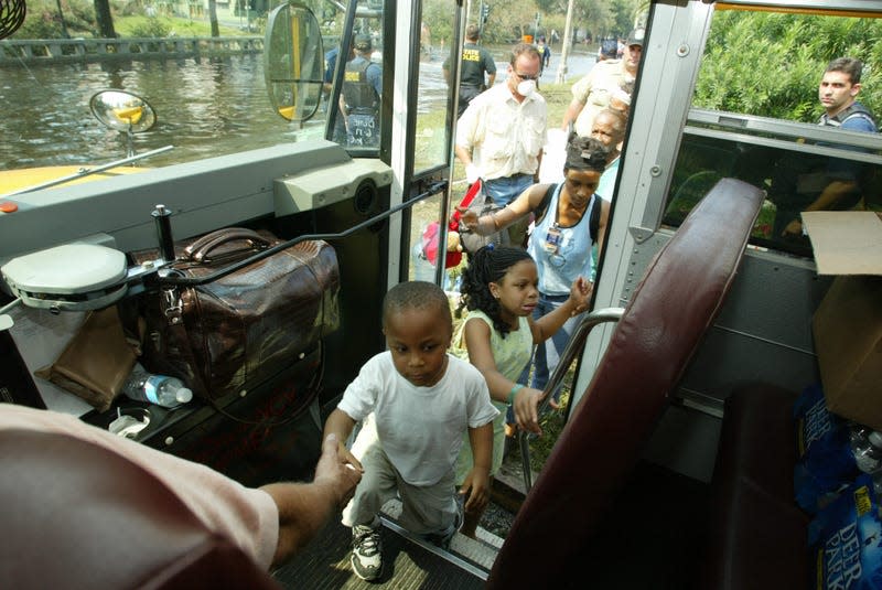 Evacuees of Hurricane Katrina board a bus to leave New Orleans. 