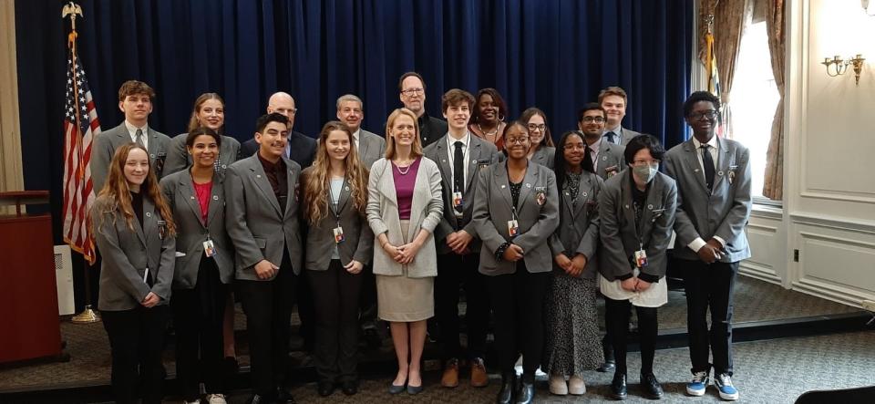 Comptroller Brooke Lierman, center (in purple shirt), stands with student pages in Annapolis, Maryland in February 2023. Lierman, elected in November, is a veteran of the General Assembly's page program for high school seniors.