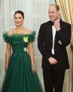 <p>One highlight of Kate and William's tour of the Caribbean was <a href="https://www.townandcountrymag.com/style/fashion-trends/g39476277/kate-middleton-caribbean-tour-2022-photos/" rel="nofollow noopener" target="_blank" data-ylk="slk:Kate's glamorous moments;elm:context_link;itc:0;sec:content-canvas" class="link ">Kate's glamorous moments</a>. Here, she wore a sparkly green off-the-shoulder Jenny Peckham gown, with the Royal Family Order and the GCVO Star pinned to her dress at a reception dinner hosted by the Governor General of Jamaica. <br></p>
