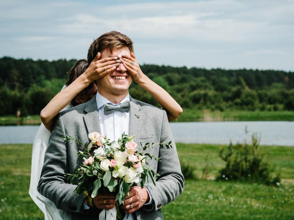 wedding first look, a bride covering her groom's eyes with her hands