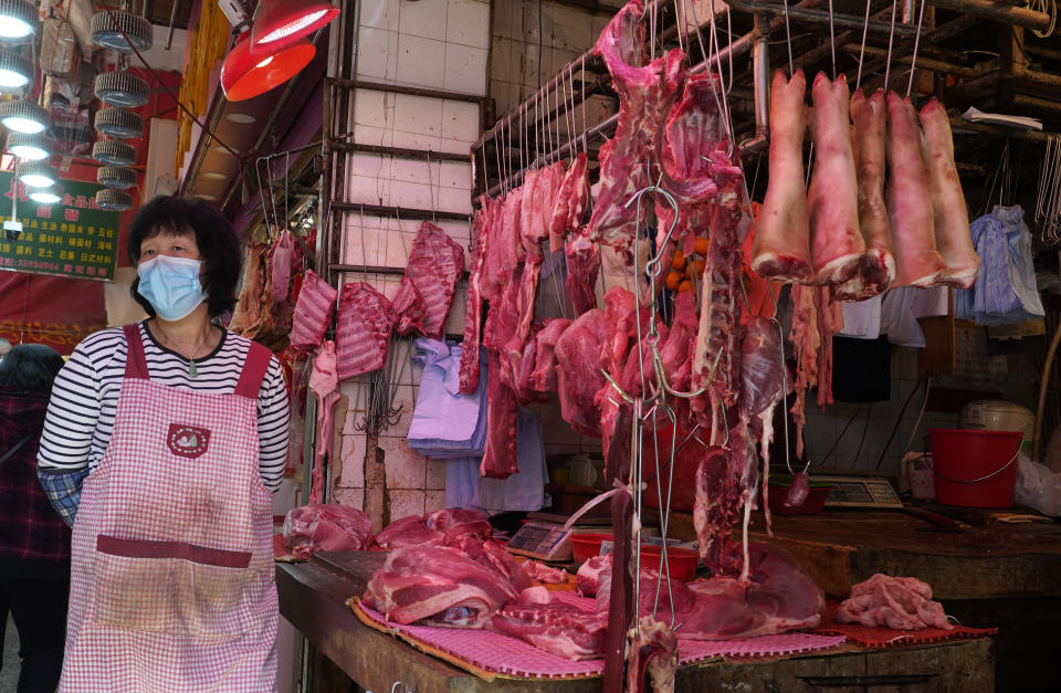 A vendor wears a face mask selling meat at a market in Hong Kong, Friday, Jan. 31, 2020. The World Health Organization declared the outbreak sparked by a new virus in China that has spread to more than a dozen countries a global emergency after the number of cases spiked more than tenfold in a week, including the highest death toll in a 24-hour period reported Friday. (AP Photo/Vincent Yu)