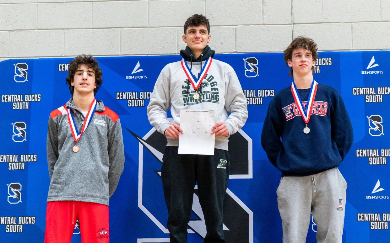 Pennridge's Cole Coffin (center) won last week's Suburban One League Colonial Division title at 121 pounds.