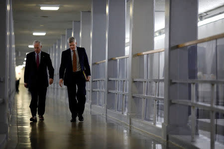 Sen. Ron Johnson (R-WI) (L) and Sen. Bill Cassidy (R-LA) walk to the party luncheons on Capitol Hill in Washington, U.S. January 23, 2018. REUTERS/Aaron P. Bernstein