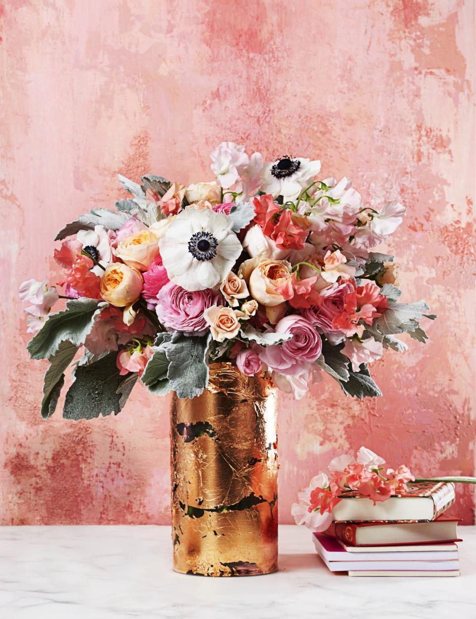 <p>Upgrade a plain glass container with this DIY makeover. A pretty mix of garden roses, ranunculus, sweet peas and anemones look extra glam with a gilded finish. </p><p><em><a href="https://www.goodhousekeeping.com/home/craft-ideas/how-to/g597/diy-vase-upgrades/?slide=1" rel="nofollow noopener" target="_blank" data-ylk="slk:Get the tutorial »;elm:context_link;itc:0;sec:content-canvas" class="link ">Get the tutorial »</a></em> </p>