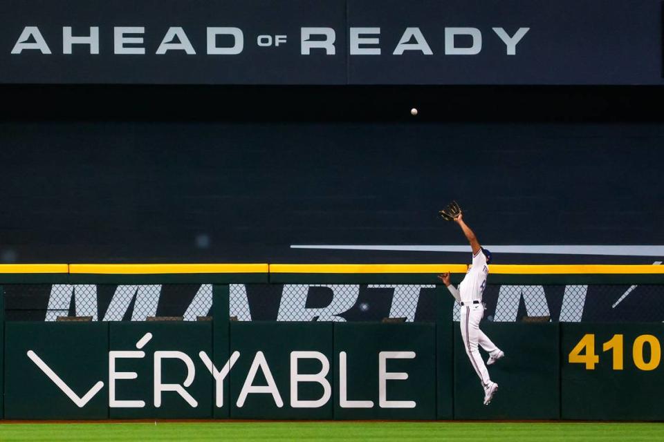 Rangers outfielder Bubba Thompson catches a ball on March 30, 2023, at Globe Life Field in Arlington. The Texas Rangers beat the Philadelphia Phillies 11-7.