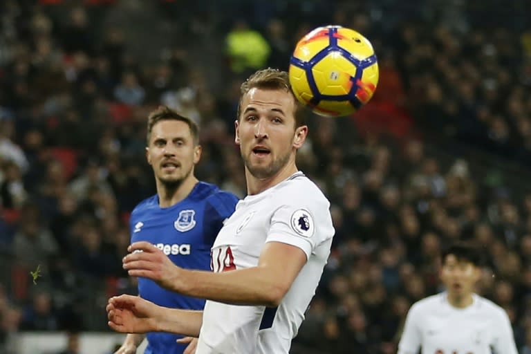 Tottenham Hotspur's striker Harry Kane (R) scores the team's third goal during the English Premier League football match against Everton January 13, 2018