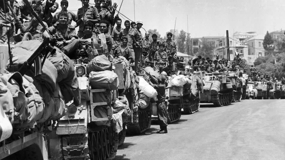 A long line of Israeli armoured personnel carriers and their crews wait on the outskirts of Beirut, in the summer of 1982. - Maz Nash/AP