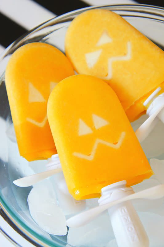 <p>Bea and Bear</p><p>Fun Halloween jack-o'-lantern ice pops for kids!</p><p><strong>Get the recipe: <a href="https://bebeandbear.com/2016/10/26/halloween-jack-o-lantern-ice-pops/" rel="nofollow noopener" target="_blank" data-ylk="slk:Halloween Jack-O'-Lantern Ice Pops;elm:context_link;itc:0;sec:content-canvas" class="link rapid-noclick-resp">Halloween Jack-O'-Lantern Ice Pops</a></strong></p>