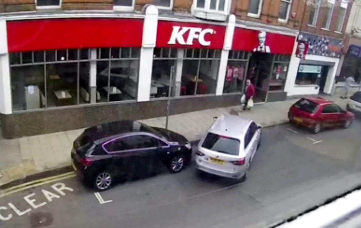 A nightmare parker smashed into two cars whilst trying to parallel park outside a KFC, all caught on video.  See SWNS story SWNNpark.  It was only a few weeks since Lisa Berry's car was repainted and fitted with a new bumper after it was hit whilst parked in the same place on Margate High Street in Kent.  The video captures the motorist's disastrous attempts as the Skoda bashes into two cars outside the fast food restaurant.  The driver of the silver estate tries to parallel park between two other cars, but instead mounts the kerb then shunts into the car in front before reversing into Lisa's car behind.  After finally getting into the spot, the driver decides it's time to go and drives off without leaving their details.  Miss Berry, who owns the stricken black Vauxhall Astra that was left scratched and dented after the parking fail, said it was the third time her car had been hit while parked near her home. 