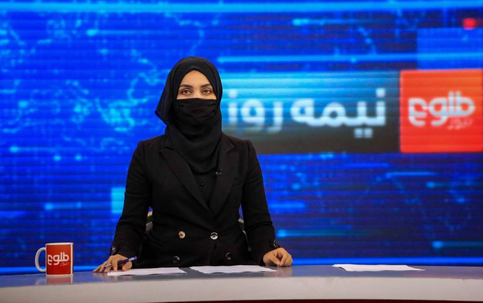 Khatira Ahmadi, an Afghan presenter at Tolo TV reads news at the studio in Kabul, Afghanistan - STRINGER/EPA-EFE/Shutterstock