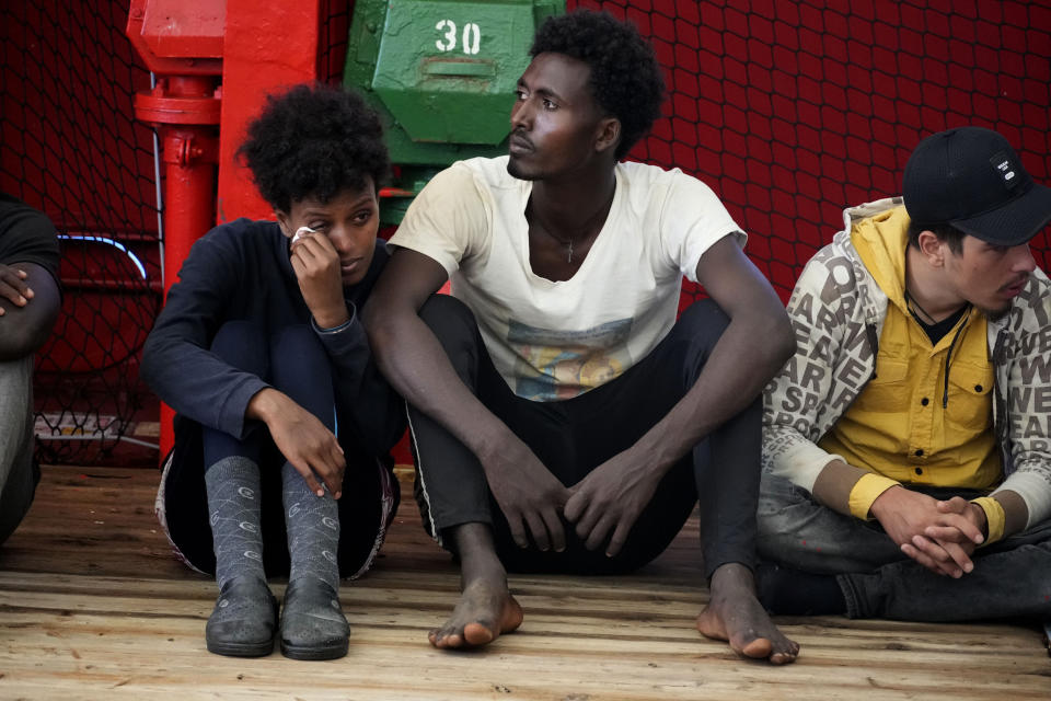 Migrants sit on the deck after being rescued by the Spanish NGO Open Arms lifeguards during a rescue operation in the international waters zone near Tunisia, Mediterranean sea, Saturday, Sept. 17, 2022. Fifty-nine migrants from Syria, Egypt, Sudan and Eritrea, 10 of them minors, were rescued by NGO Open Arms crew members. (AP Photo/Petros Karadjias)