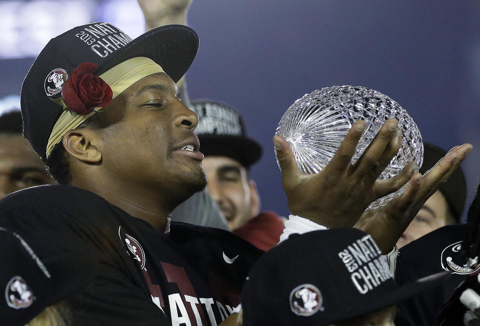 Florida State's Jameis Winston with The Coaches' Trophy after the NCAA BCS National Championship college football game against Auburn Monday, Jan. 6, 2014, in Pasadena, Calif. Florida State won 34-31. (AP Photo/David J. Phillip)