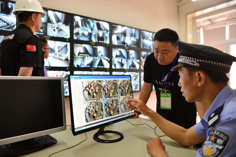 A police officer monitors examination venues as students sit for China's national college entrance exam known as "gaokao", in Tianjin, China June 7, 2017.