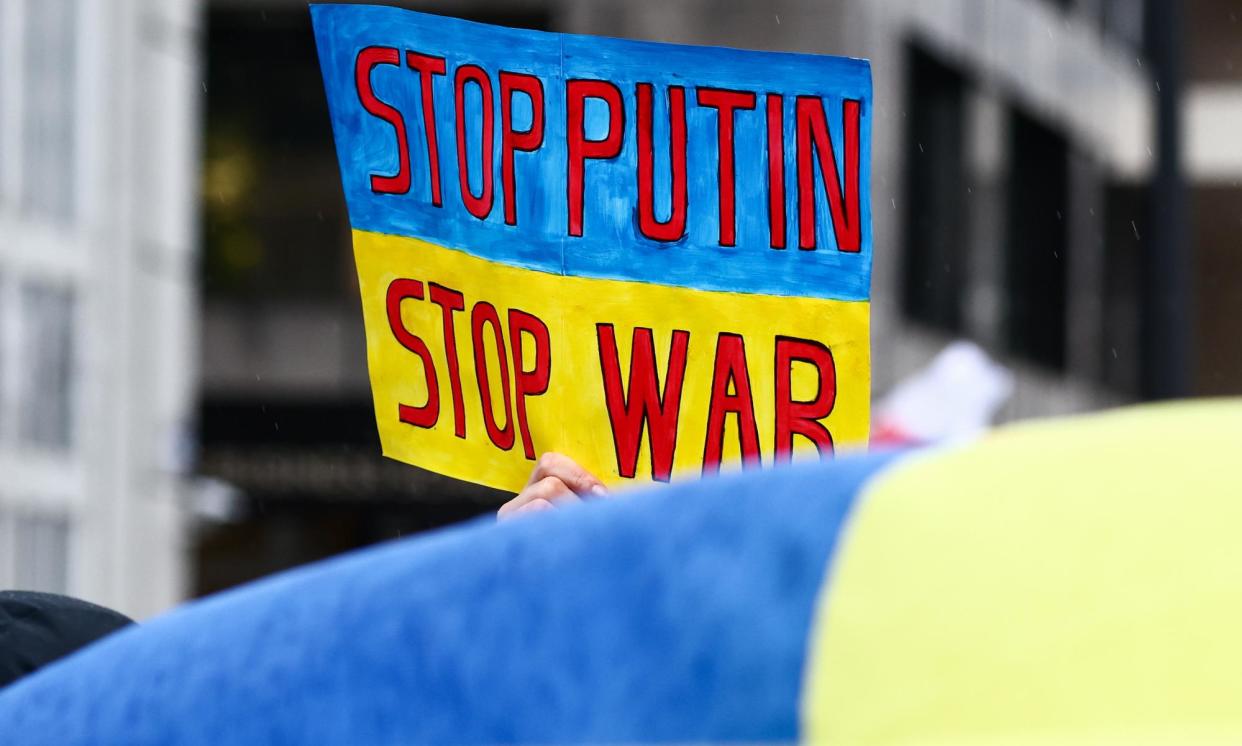 <span>A sign protesting against Russia’s invasion of Ukraine. Whether sanctions will stop Putin and the Ukraine war, however, remains to be seen.</span><span>Photograph: Stéphanie Lecocq/EPA</span>