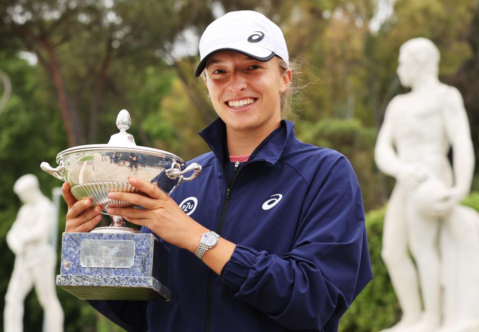 Iga Swiatek (pictured) poses with the winners trophy in Rome.