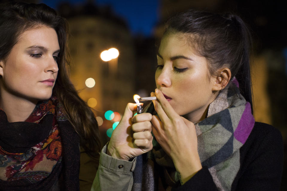 Young women smoking marijuana together (GETTY)