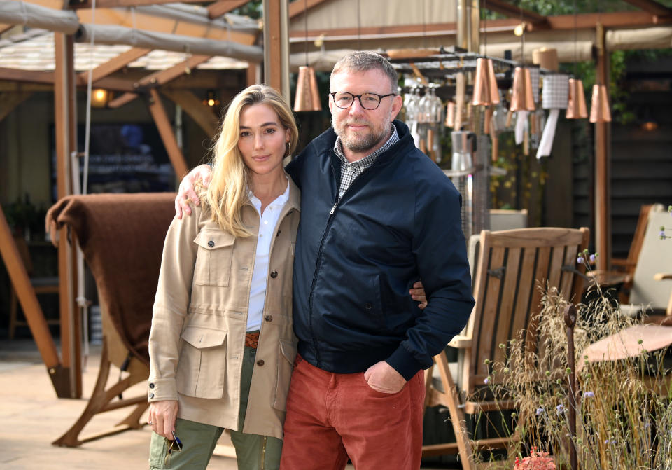 LONDON, ENGLAND - SEPTEMBER 20: Jacqui Ainsley and Guy Ritchie in front of his stand ‘The Cashmere Caveman Company’ at the Chelsea Flower Show on September 20, 2021 in London, England. This year's RHS Chelsea Flower Show was delayed from its usual spring dates due to the Covid-19 pandemic, which also prompted its cancellation last year. Previously, only two World Wars had caused the event's suspension. (Photo by Karwai Tang/WireImage)