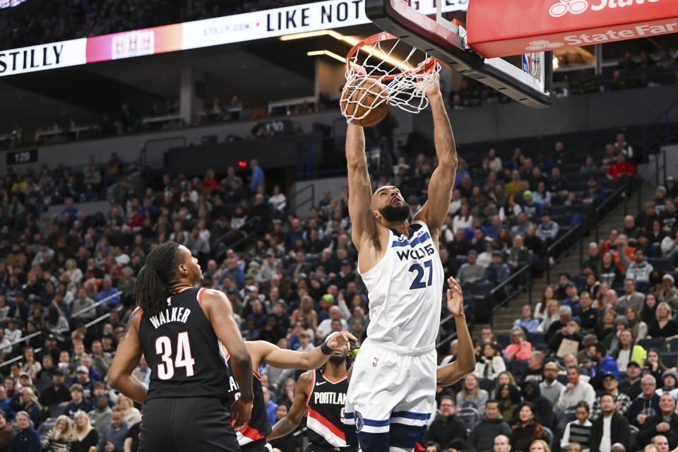 Minnesota Timberwolves center Rudy Gobert (27) dunks as Portland Trail Blazers forward Jabari Walker (34) watches during the first half of an NBA basketball game Friday, Jan. 12, 2024, in Minneapolis. (AP Photo/Craig Lassig)