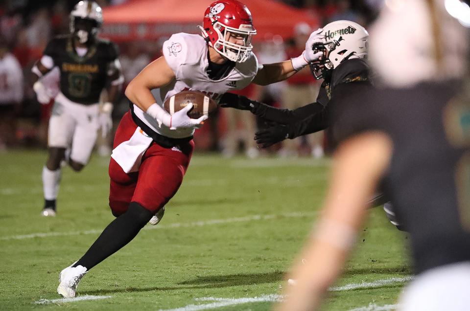 Savannah Christian's Logan Brooking throws a stiff-arm as he gains yardage on Friday, September 15, 2023 against Savannah Country Day.