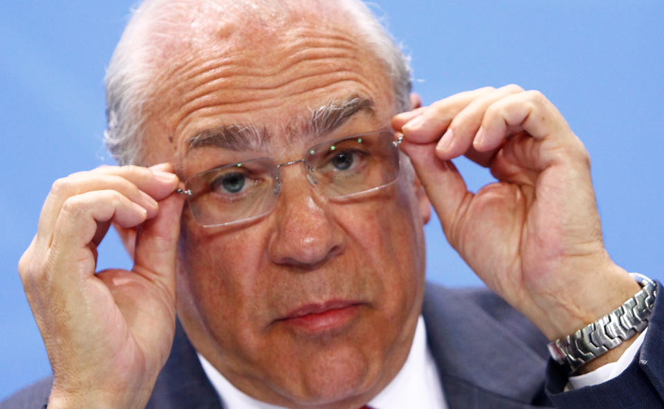 Jose Angel Gurria, Secretary-General of the Organisation for Economic Co-operation and Development (OECD) adjusts his glasses as he attends a news conference  with representatives of the trade organizations after a meeting in the chancellery in Berlin, Germany, June 11, 2018. REUTERS/Michele Tantussi