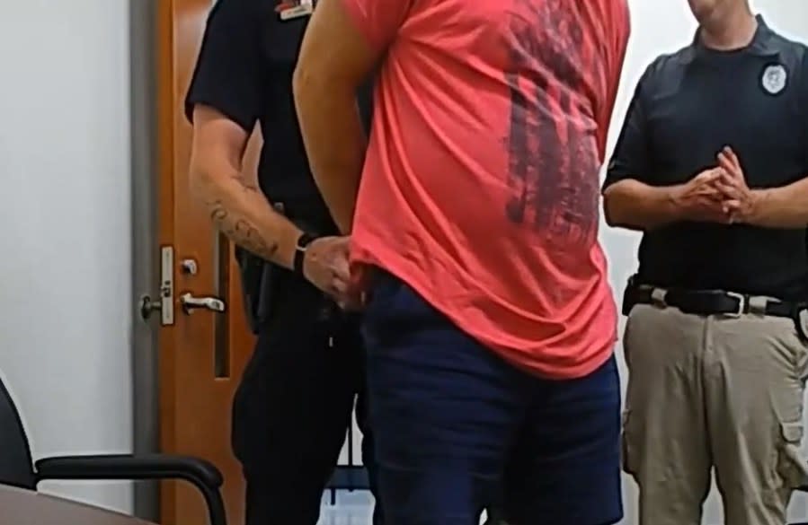 Police handcuff Robert Waters. (Courtesy)