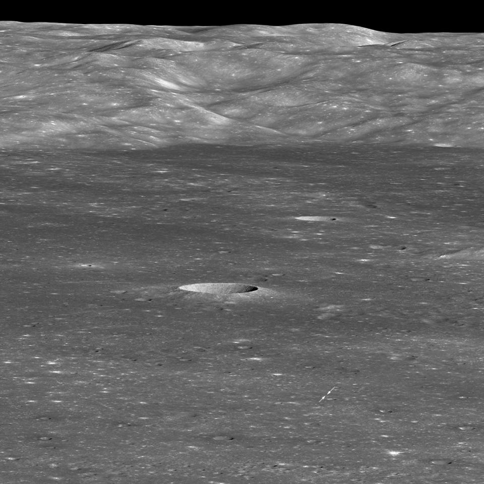 Arrows indicate the position of China’s Chang'e 4 lander on the floor of Von Kármán Crater in this image captured by NASA’s Lunar Reconnaissance Orbiter (LRO) on Jan. 30, 2019. The sharp crater behind and to the left of the landing site is 12,800 feet (3,900 meters) wide and 1,970 feet (600 m) deep. <cite>NASA/GSFC/Arizona State University</cite>