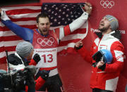<p>David Gleirscher of Austria is congratulated by a teammates after winning gold while Chris Mazdzer of the United States celebrates in the background after he won silver in the Luge Men’s Singles on day two of the PyeongChang 2018 Winter Olympic Games at Olympic Sliding Centre on February 11, 2018 in Pyeongchang-gun, South Korea. (Photo by Ezra Shaw/Getty Images) </p>
