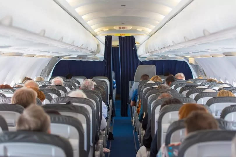 Commercial aircraft cabin with passengers