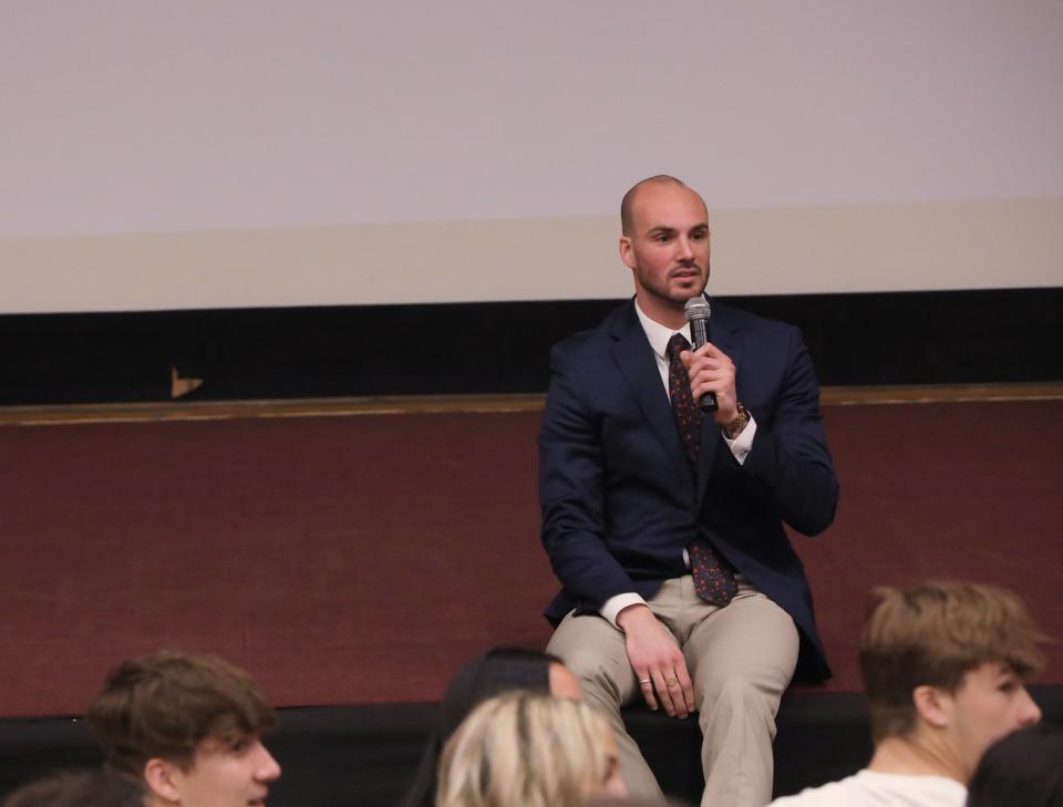 Luke Timm, a 2016 graduate from Our Lady of Lourdes High School, talks about his struggles with drug addiction during an assembly at the high school on May 10, 2023. 