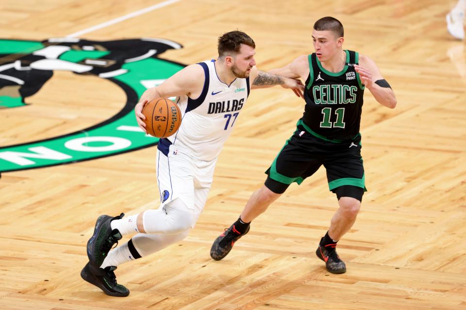 Luka Doncic (77) dribbles the ball against the Boston Celtics' Payton Pritchard during Game 2.