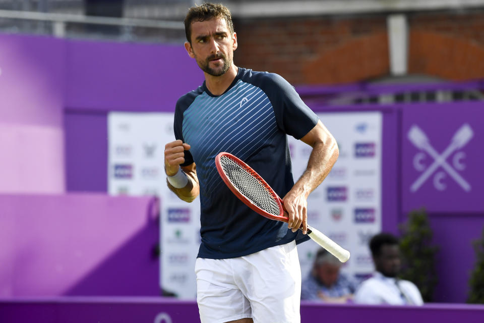 Marin Cilic of Croatia celebrates a point against Fabio Fognini of Italy during their singles tennis match at the Queen's Club tournament in London, Wednesday, June 16, 2021.(AP Photo/Alberto Pezzali)