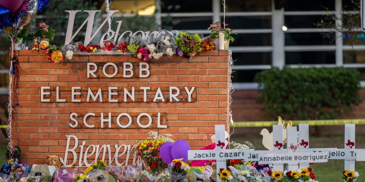 A memorial is seen surrounding the Robb Elementary School sign