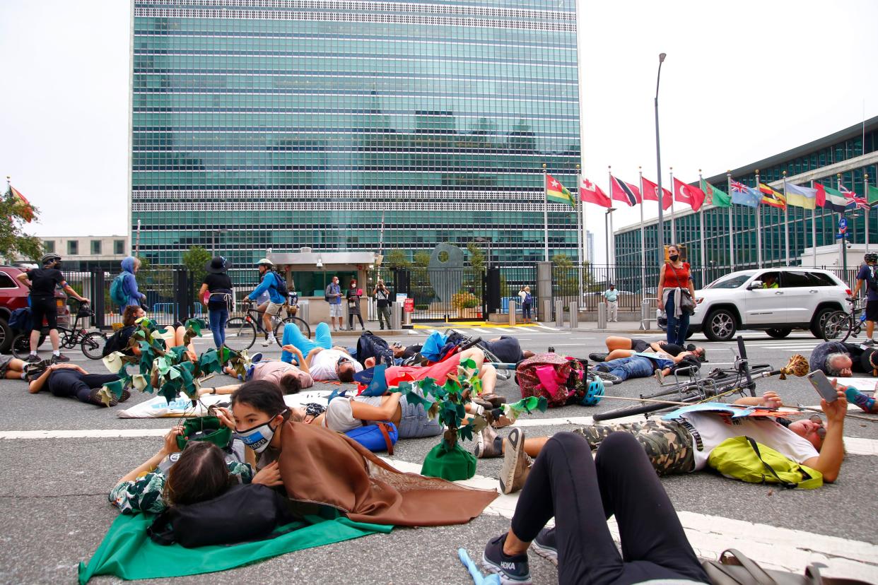 People perform a die-in in front of the United Nations on September 17, 2021 to bring attention to the effects of climate change ahead of the annual gathering of world leaders for the United Nations General Assembly.