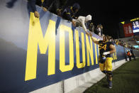 West Virginia's Zach Frazier (54) high-fives fans after an NCAA college football game against Cincinnati, Saturday, Nov. 18, 2023, in Morgantown, W.Va. West Virginia won 42-21. (AP Photo/Chris Jackson)