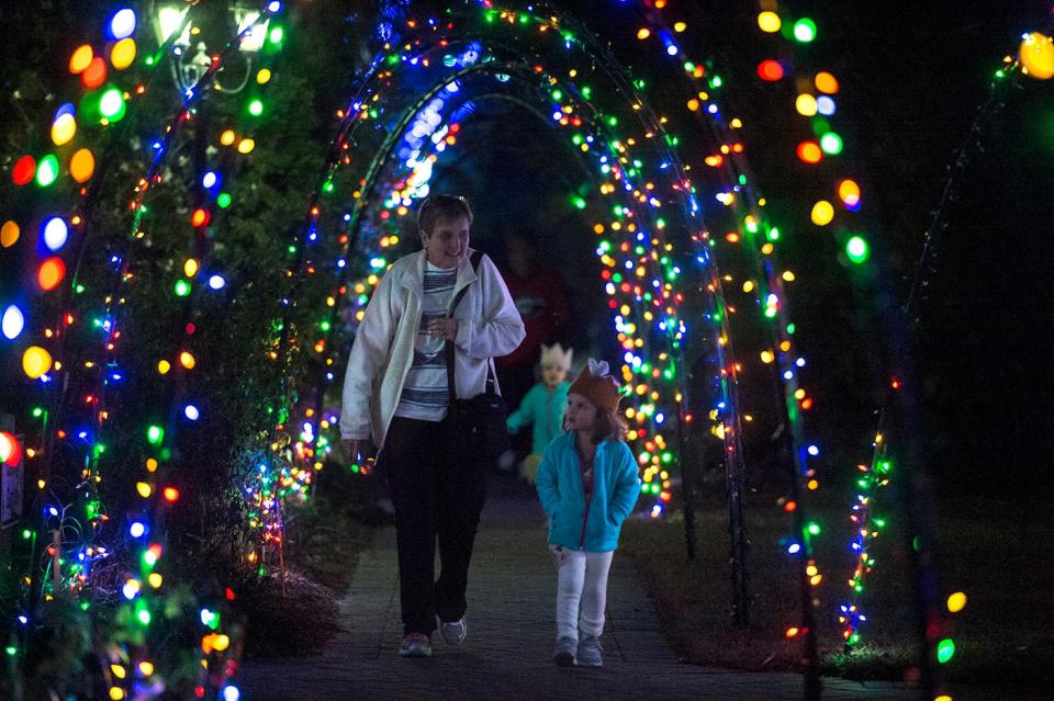 Amy Carter walks with her granddaughter Mary Margeret at the December Nights and Holiday Lights tour at the Coastal Botanical Gardens on Wednesday. (Josh Galemore/Savannah Morning News)