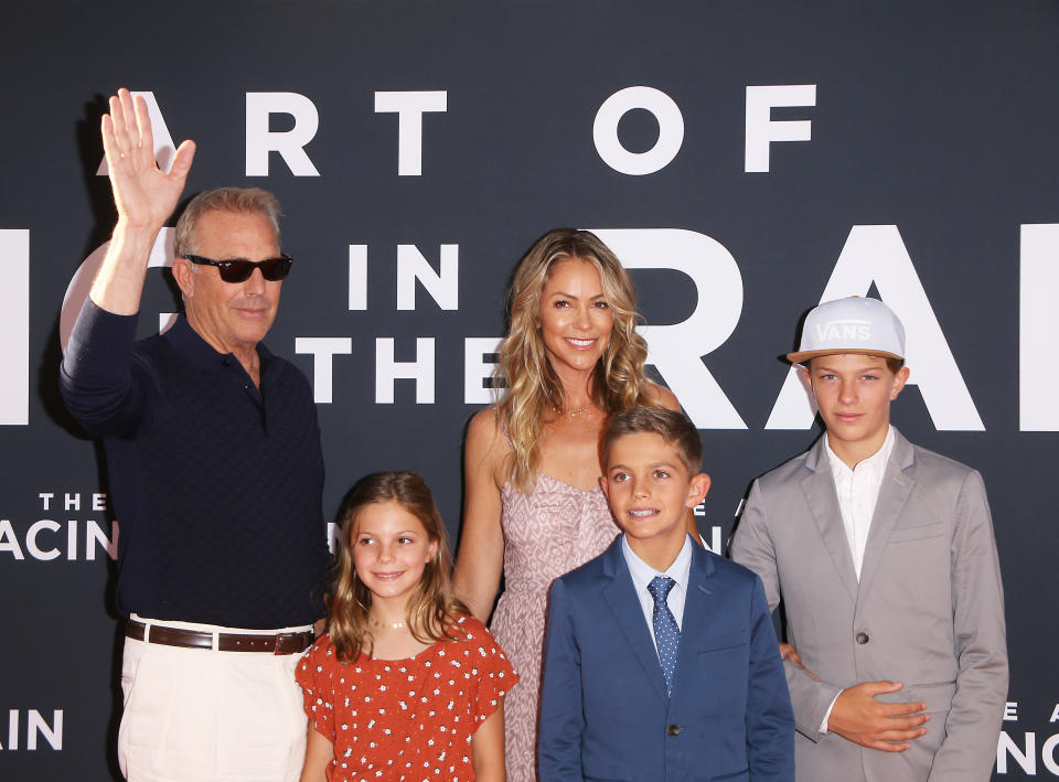 LOS ANGELES, CALIFORNIA - AUGUST 01: Kevin Costner, Christine Baumgartner and their children attend the Los Angeles premiere of 20th Century Fox's "The Art of Racing In The Rain" held at El Capitan Theatre on August 01, 2019 in Los Angeles, California. (Photo by Michael Tran/FilmMagic)