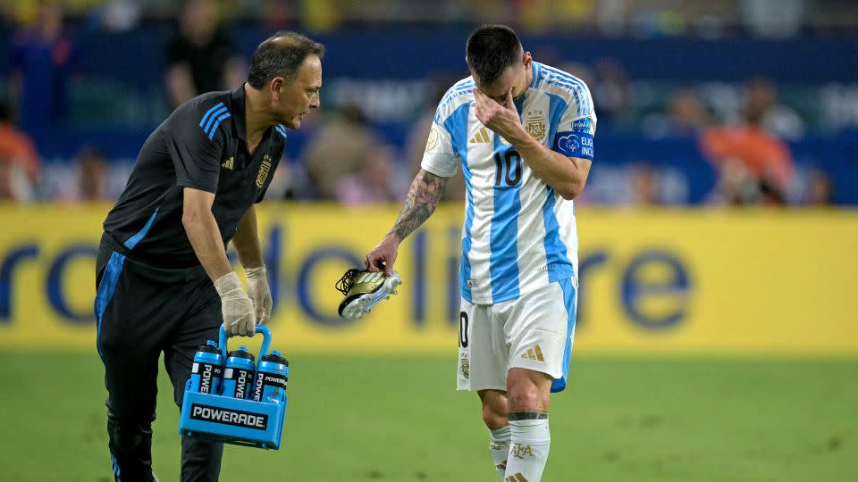 Argentine captain Lionel Messi leaves the pitch after an apparent ankle injury during the Copa America final against Colombia on July 14, 2024. - Juan Mabromata/AFP/Getty Images