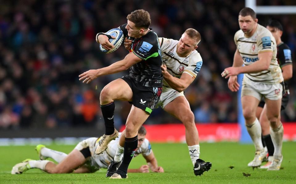 Oscar Beard of Harlequins is tackled by Chris Harris of Gloucester Rugby