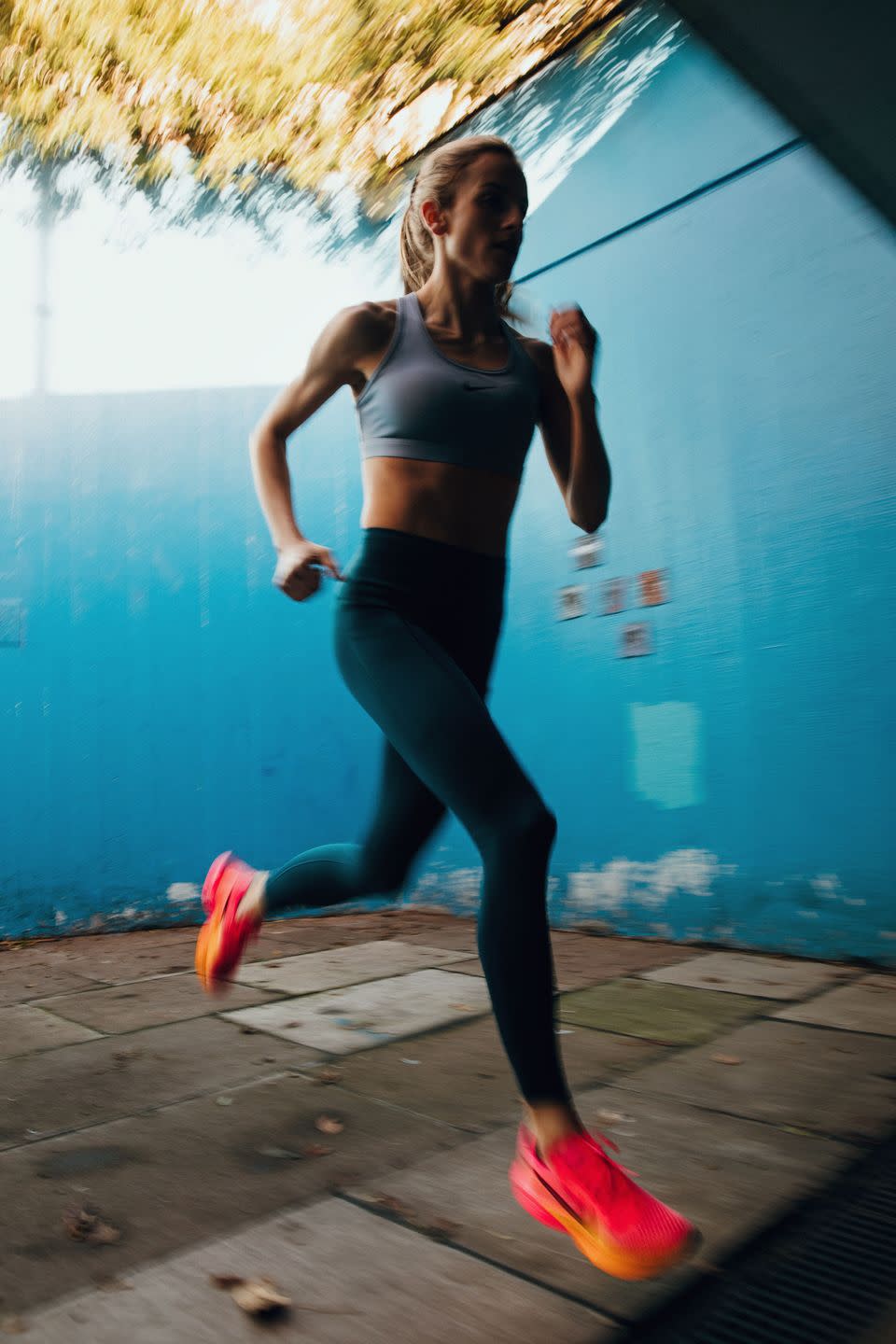 a woman running on a sidewalk