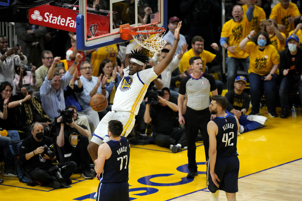 The Golden State Warriors will make a Kevon Looney dunk shot against Dallas Mavericks' Luka Doncic and Maxi Kleber in the second quarter of the Western Conference Finals at the Chase Center in San Francisco on May 20, 2022.  (Thearon W. Henderson / Getty Images)